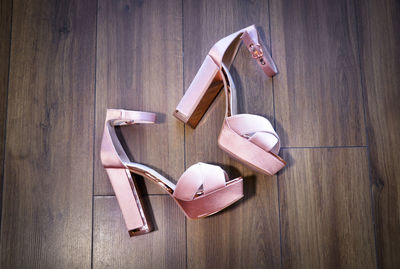 Close-up of high heels on wooden table