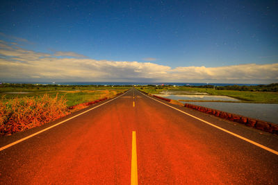 Empty road along countryside landscape