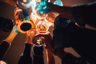Cropped image of people toasting drinks