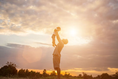 Side view of man playing against sky during sunset