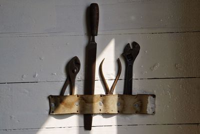 Close-up of padlock on table against wall