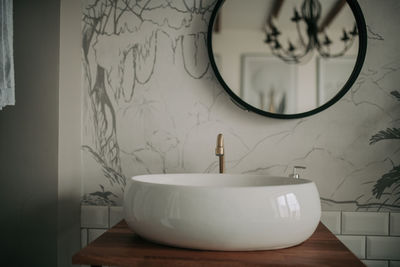 Luxury interior of big bathroom at modern african style with oval bathtub in natural lighting