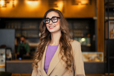 Portrait of smiling woman at cafe