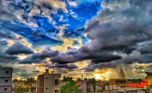 View of townscape against dramatic sky