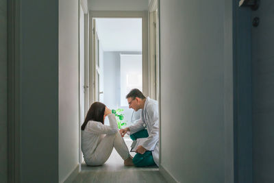 Doctor assisting patient at clinic