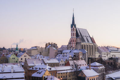 View of buildings in city against clear sky