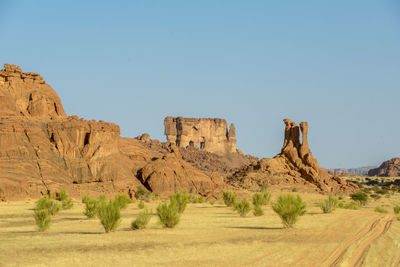 Rock formations on landscape against clear sky