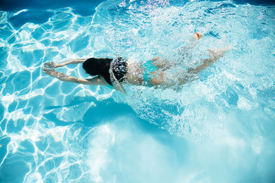 High angle view of woman swimming in pool