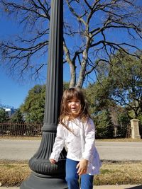 Portrait of smiling girl against plants