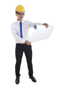 Full length of a young man standing against white background