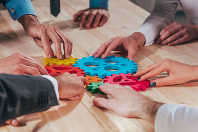Midsection of business colleagues working on table