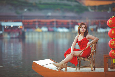 Asian woman wearing cheongsam traditional red dress on chinese new year travel.