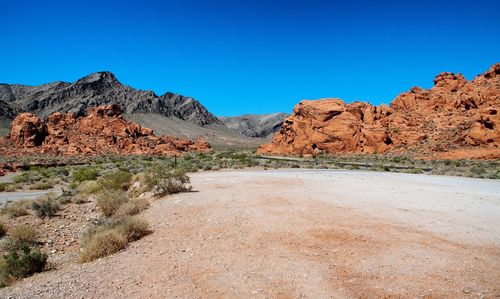 Scenic view of mountains against clear blue sky