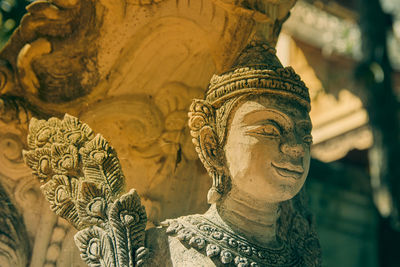 Close-up of buddha statue against building