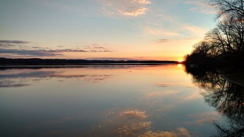 Scenic view of river against sky during sunset