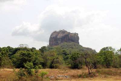 Rock formations on landscape against sky