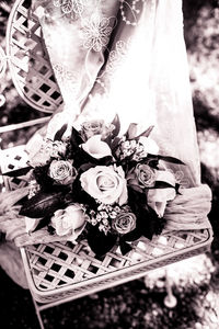 Low section of woman with flower bouquet