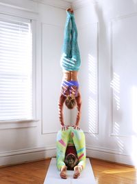 Females friends doing yoga at studio