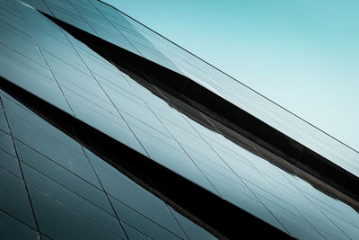 Low angle view of modern building against clear blue sky