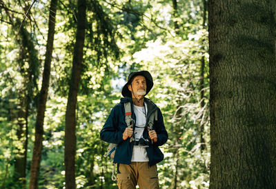 Young woman standing in forest