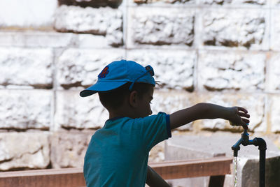 Boy standing against wall