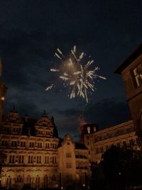 Low angle view of firework display at night