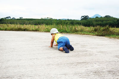 Rear view of boy on field