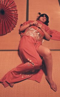 Full length portrait of young woman lying down