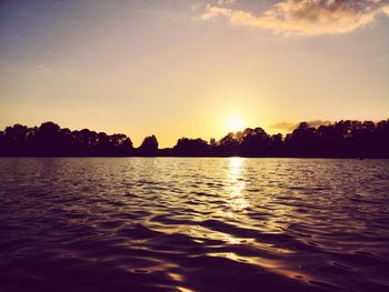 Scenic view of lake against sky during sunset