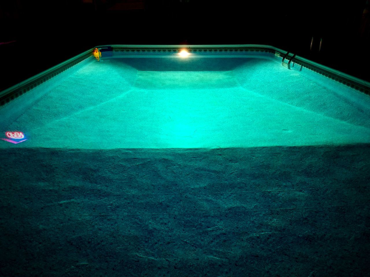 HIGH ANGLE VIEW OF ILLUMINATED POOL