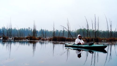 People sitting on boat in lake