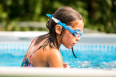 Portrait of young woman swimming in pool