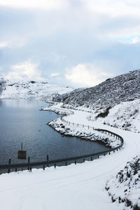 Snow  montain road near the lake