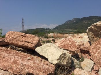 Rocks on mountain against clear blue sky