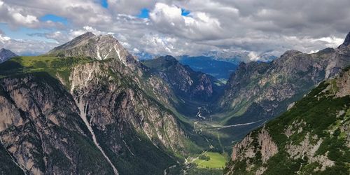 Panoramic view of mountains and valley against cloudy sky