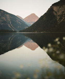 Scenic view of snowcapped mountains against sky at plansee in austria. shot on kodak portra 400 film