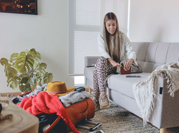 Portrait of woman sitting on sofa at home