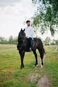 Man riding horse on field