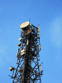 Low angle view of communications tower against sky