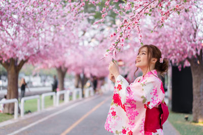 Woman holding cherry blossoms in spring