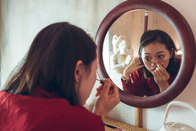 Portrait of woman making face with reflection