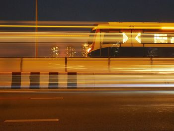 Blurred motion of light trails on road at night