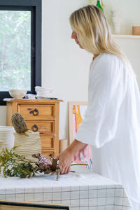 Portrait of the female florist working at her home studio