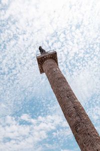 Low angle view of snow on wood against sky