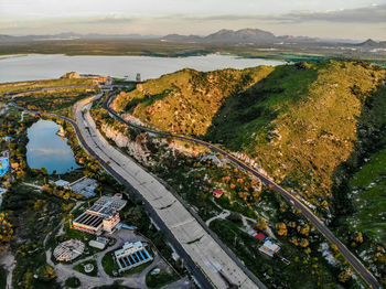 High angle view of city by road against sky