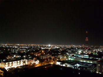 High angle view of city lit up at night