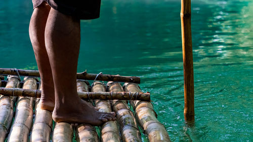 Punting down a river on a bamboo raft