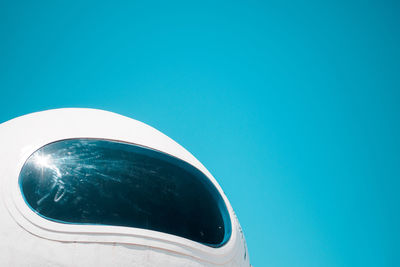 Low angle view of airplane against clear blue sky