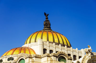 Low angle view of statue against clear blue sky