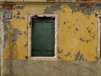 Closed door of house in decay 